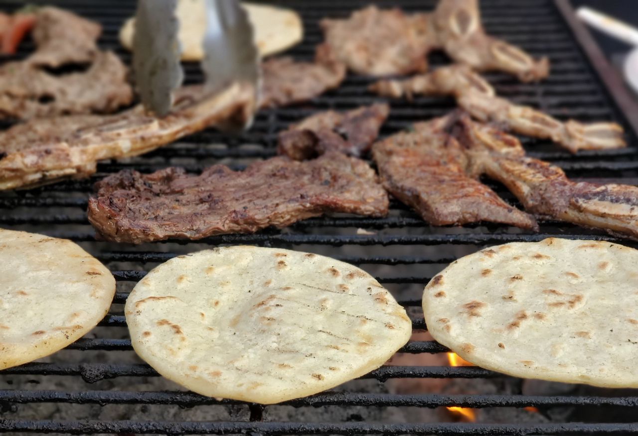 pexels-photo-8364557-8364557 Close-up of sizzling meat and tortillas grilling on a barbecue, perfect for a delicious meal.